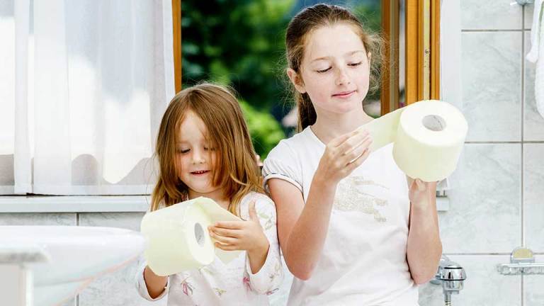 girls holding toilet paper