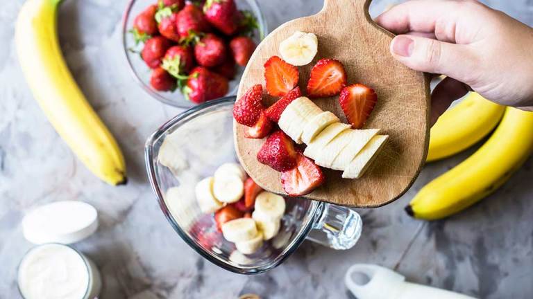 using a blender at home to blend fruit